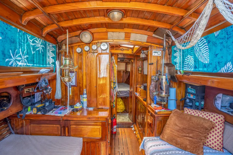 Slide: The Image of Interior of a 1950 Custom Cornu Sloop with wooden furnishings and nautical decor. - 8