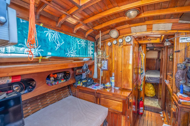 Slide: The Image of 1950 Custom Cornu Sloop interior with wooden finish and nautical decor. - 9