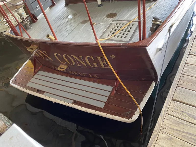 Slide: The Image of 1928 Elco Flat Top boat docked, stern view with EN CONGE name. - 2
