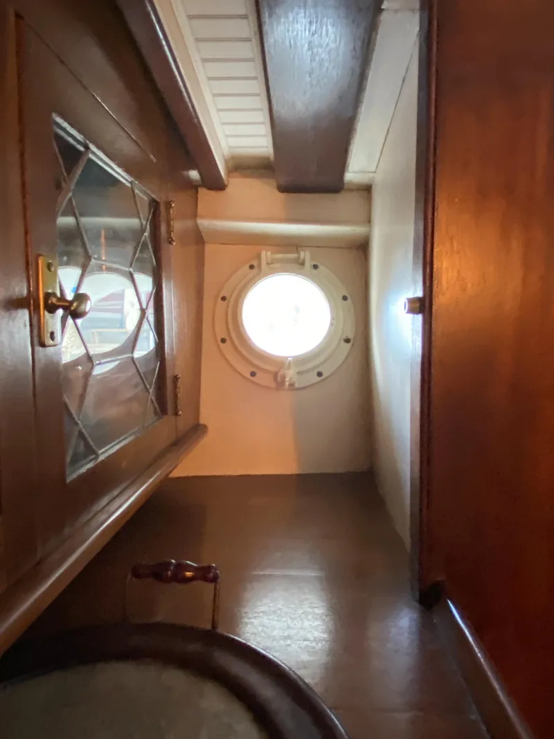 Slide: The Image of 1928 Elco Flat Top boat interior with porthole and wooden cabinetry. - 41