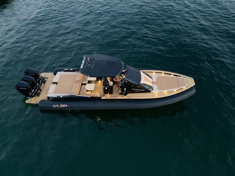 The Image of 2025 SPX RIB 38 Sport boat cruising on open water. - 0