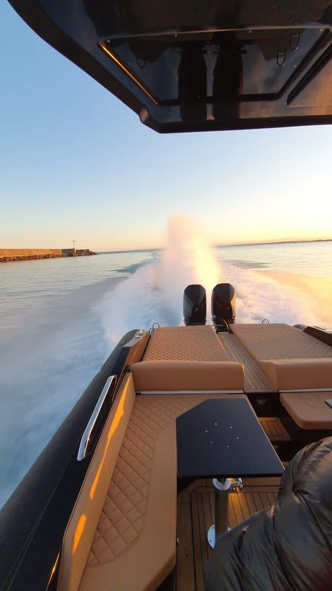 Slide: The Image of 2025 SPX RIB 38 Sport speeding on water at sunset. - 10