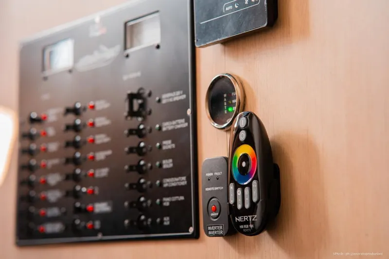 Slide: The Image of Control panel of 2025 SPX RIB 38 Sport boat with various switches and gauges. - 19