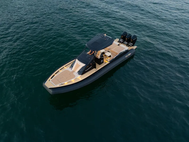 Slide: The Image of 2025 SPX RIB 38 Sport boat cruising on open water. - 2