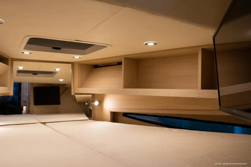Slide: The Image of Interior cabin of 2025 SPX RIB 38 Sport boat with modern lighting and wooden storage. - 20