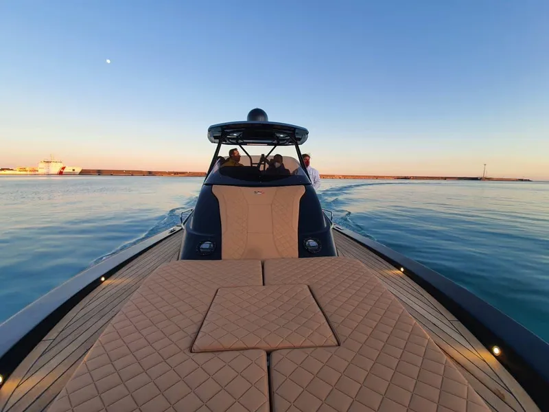 Slide: The Image of 2025 SPX RIB 38 Sport luxury boat cruising at sunset. - 7