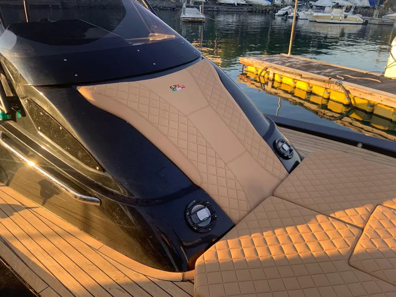Slide: The Image of 2025 SPX RIB 38 Sport luxury boat with tan upholstery docked at marina. - 8