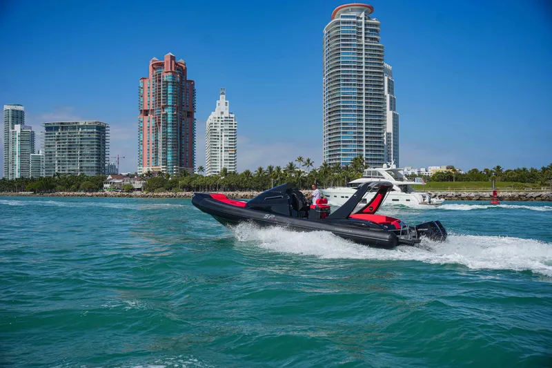 Slide: The Image of Sea Prop COMFORT 33 boat cruising near city skyline, 2025 model. - 1