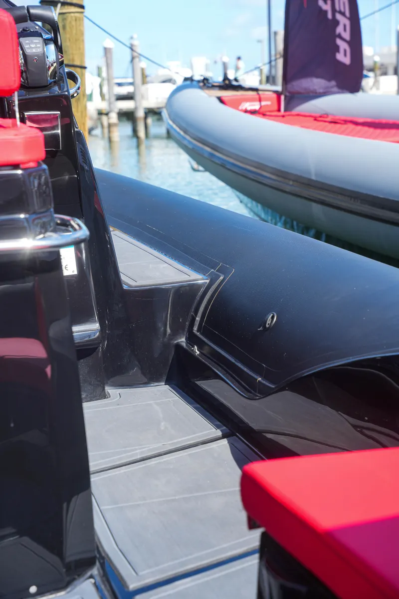 Slide: The Image of Sea Prop COMFORT 33, 2025 model, docked with sleek black and red design. - 14