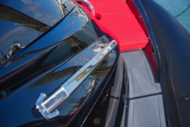 Slide: The Image of Close-up of 2025 Sea Prop COMFORT 33 boat with sleek black and red design. - 21