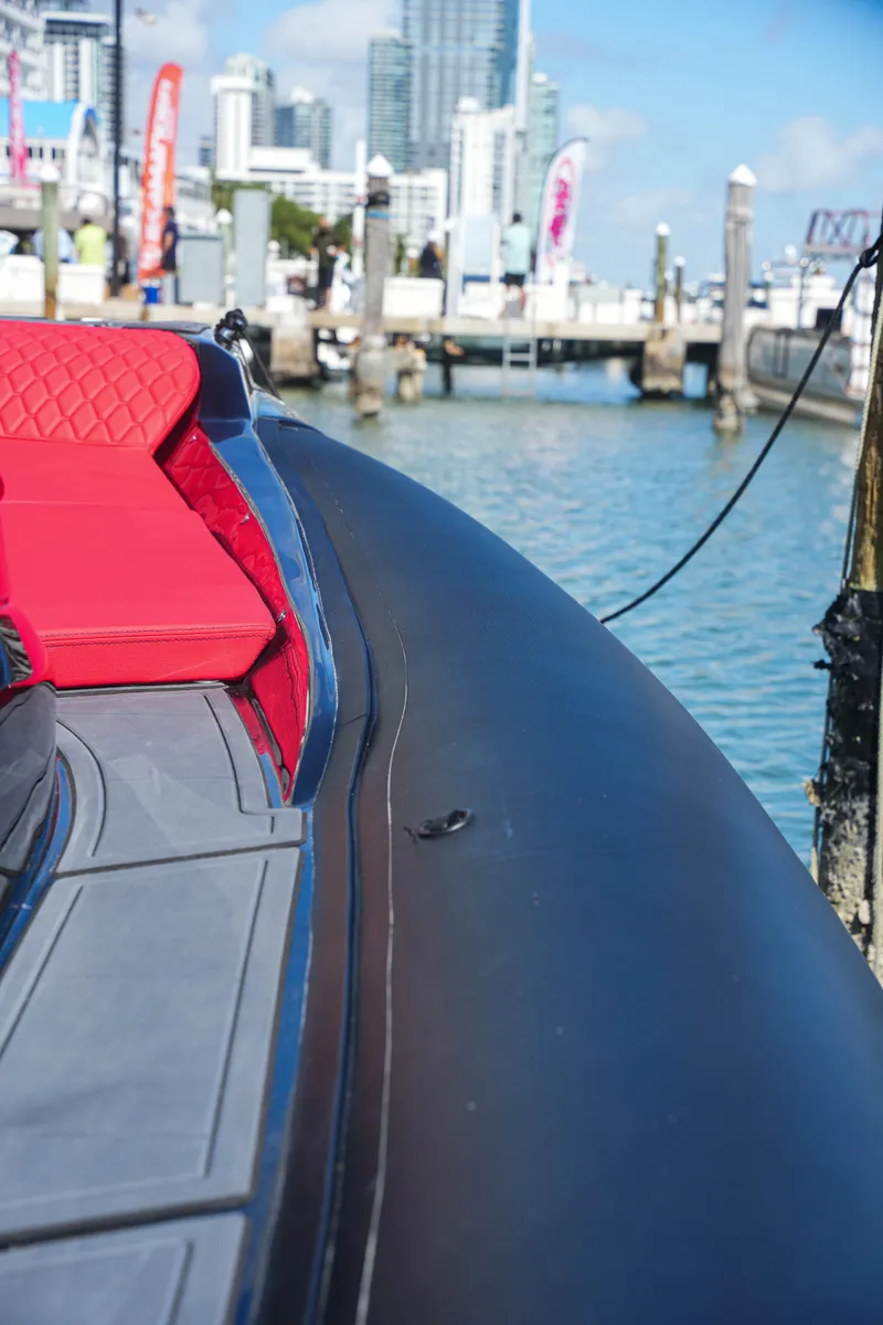 Slide: The Image of 2025 Sea Prop COMFORT 33 boat docked with red seating and cityscape background. - 22