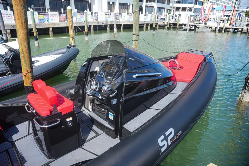 Slide: The Image of 2025 Sea Prop COMFORT 33 boat docked, featuring red seating and modern control panel. - 3