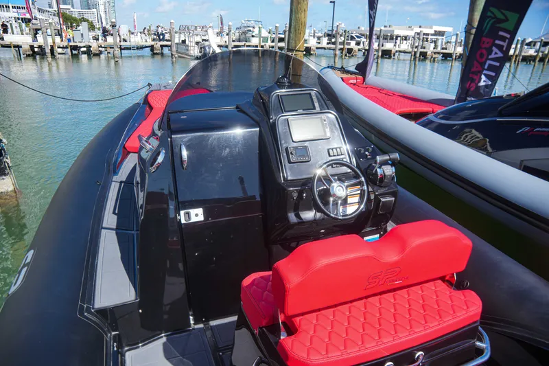 Slide: The Image of 2025 Sea Prop COMFORT 33 boat with red seating at a marina. - 5