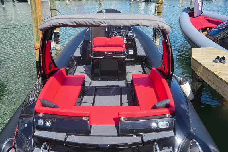 Slide: The Image of 2025 Sea Prop COMFORT 33 boat with red seating and canopy docked at marina. - 7