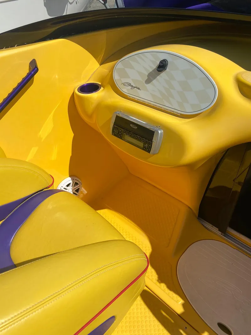Slide: The Image of 2001 Baja H2X boat interior with yellow and purple seats and dashboard. - 11