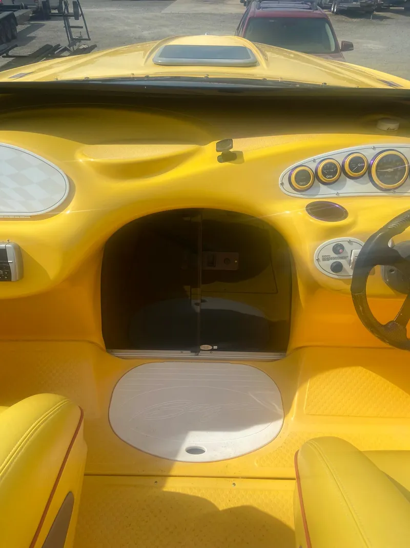 Slide: The Image of 2001 Baja H2X boat interior with yellow dashboard and steering wheel. - 21