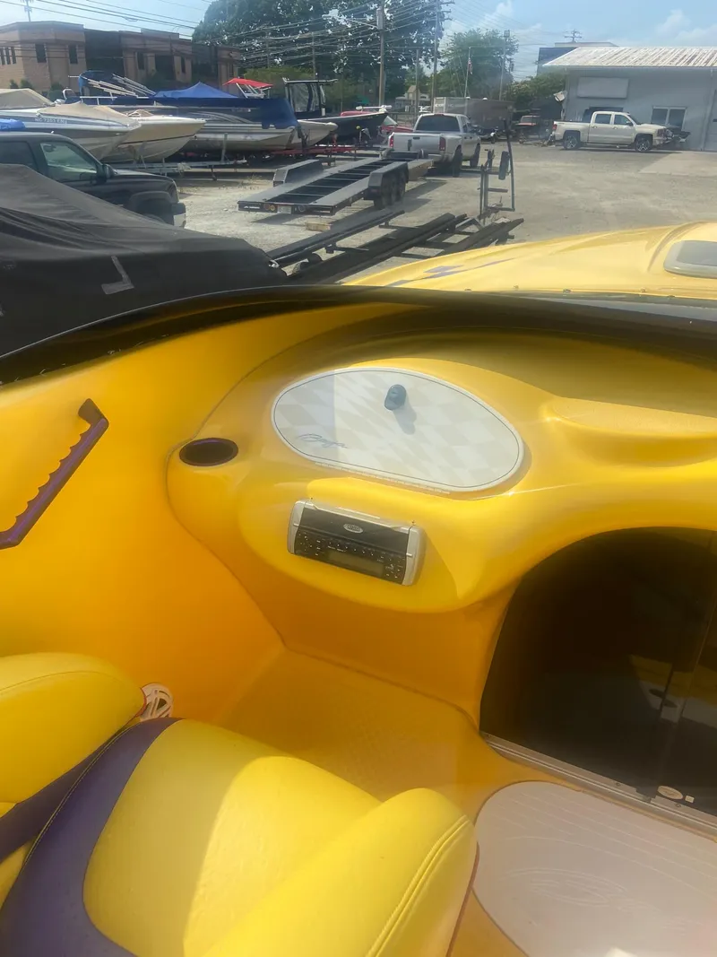Slide: The Image of Interior of a 2001 Baja H2X boat with yellow and purple seating. - 22