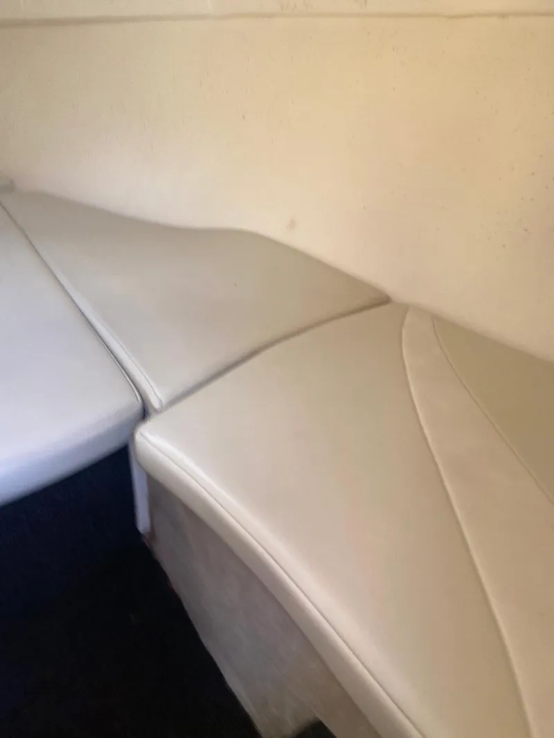 Slide: The Image of Interior seating of a 2001 Baja H2X boat with white upholstery. - 25