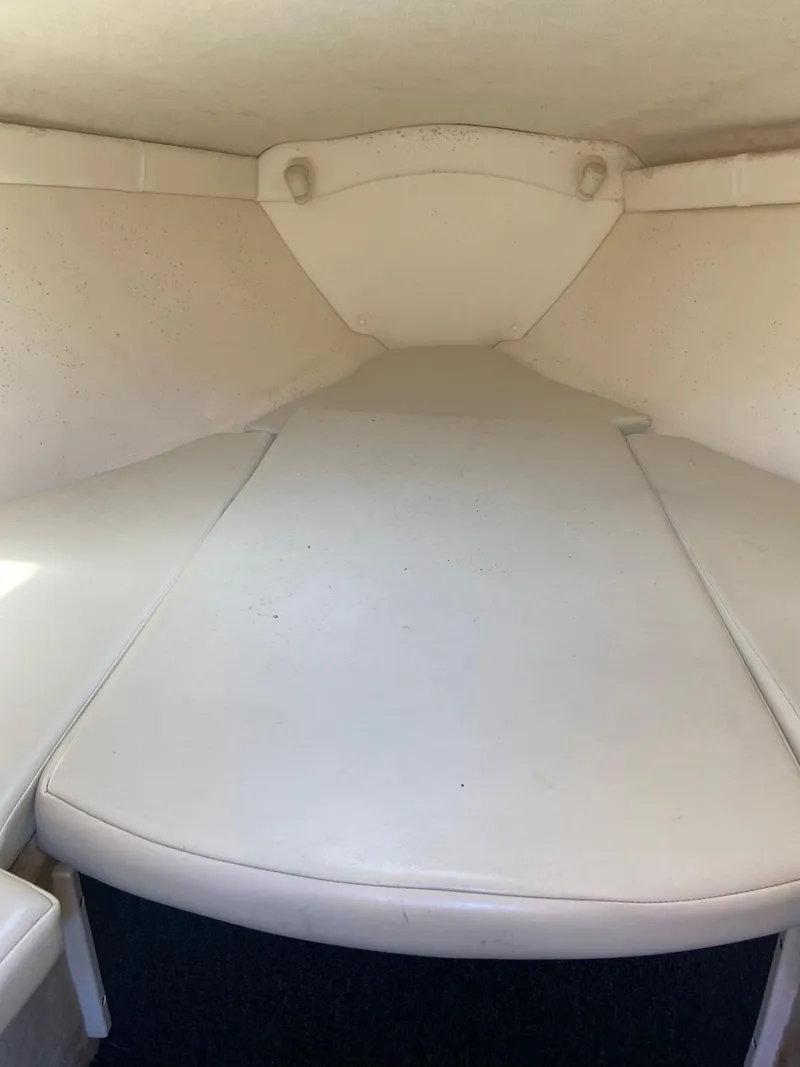 Slide: The Image of Interior cabin of a 2001 Baja H2X boat with white cushioned seating. - 26