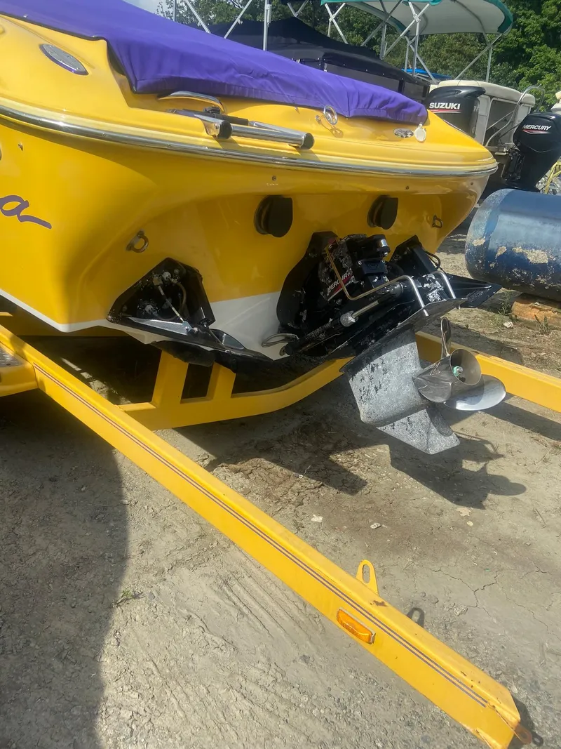 Slide: The Image of 2001 Baja H2X yellow speedboat on trailer, rear view showing outboard motor. - 33
