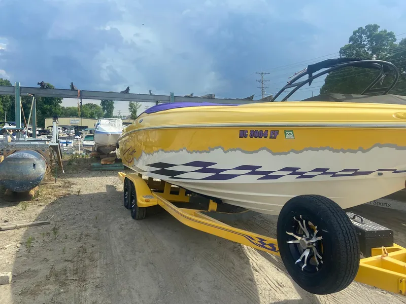 Slide: The Image of 2001 Baja H2X yellow speedboat on trailer in a boatyard. - 5