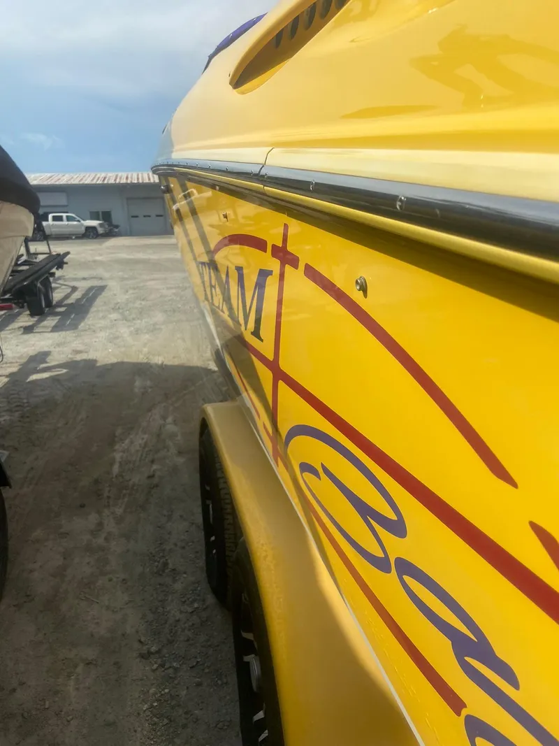 Slide: The Image of 2001 Baja H2X yellow speedboat with red and blue graphics on trailer. - 6