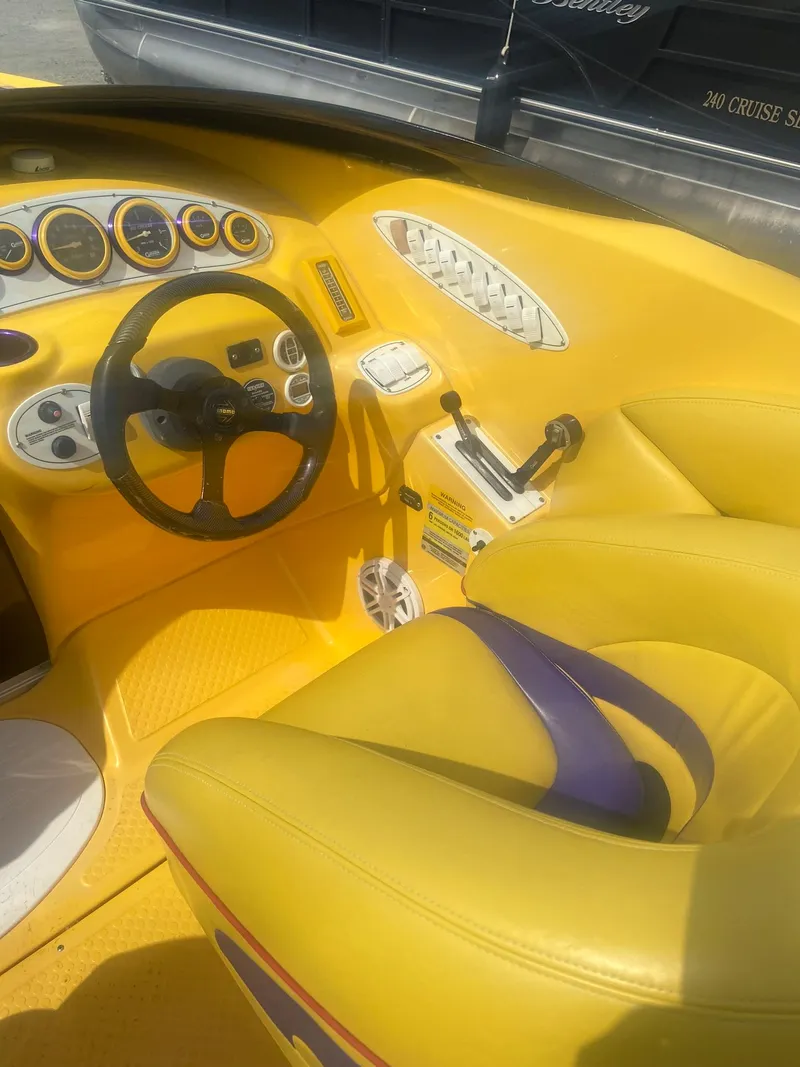 Slide: The Image of 2001 Baja H2X boat interior with yellow and purple accents. - 9