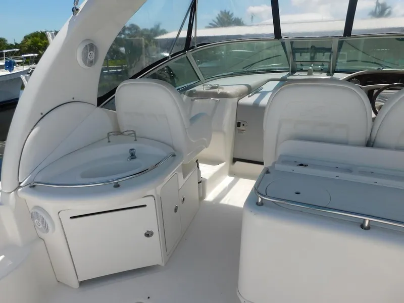 Slide: The Image of 2006 Sea Ray 340 Sundancer boat interior with white seating and sink. - 10