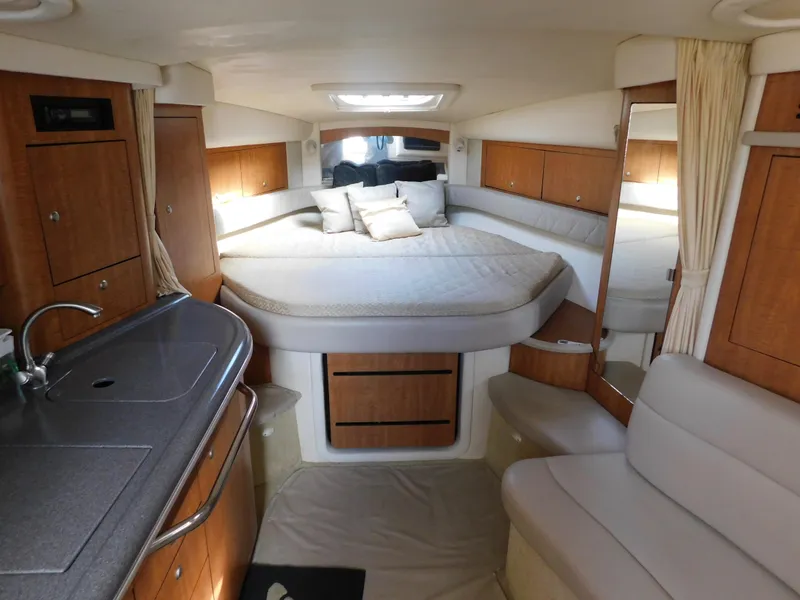 Slide: The Image of Interior of 2006 Sea Ray 340 Sundancer with bed, kitchenette, and seating area. - 16