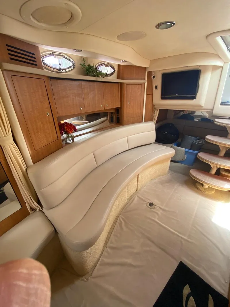Slide: The Image of Luxurious interior of a 2006 Sea Ray 340 Sundancer yacht with curved seating and TV. - 21