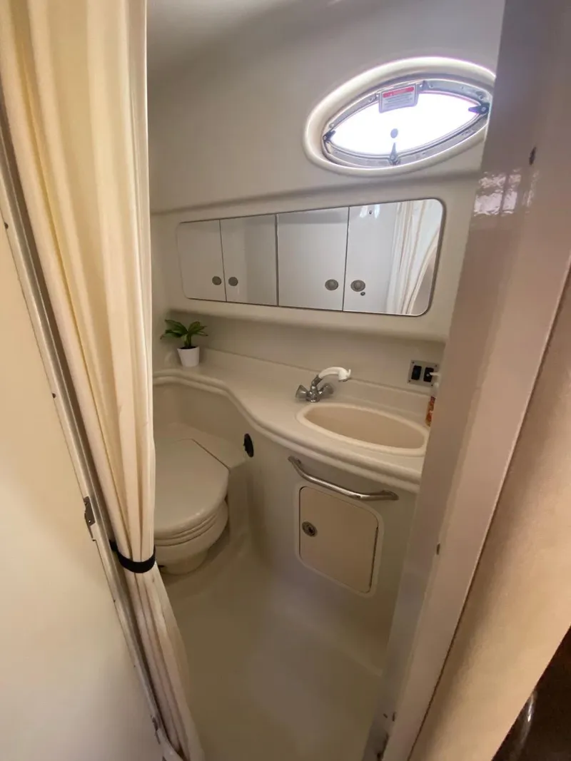 Slide: The Image of 2006 Sea Ray 340 Sundancer bathroom with sink, mirror, and porthole window. - 25