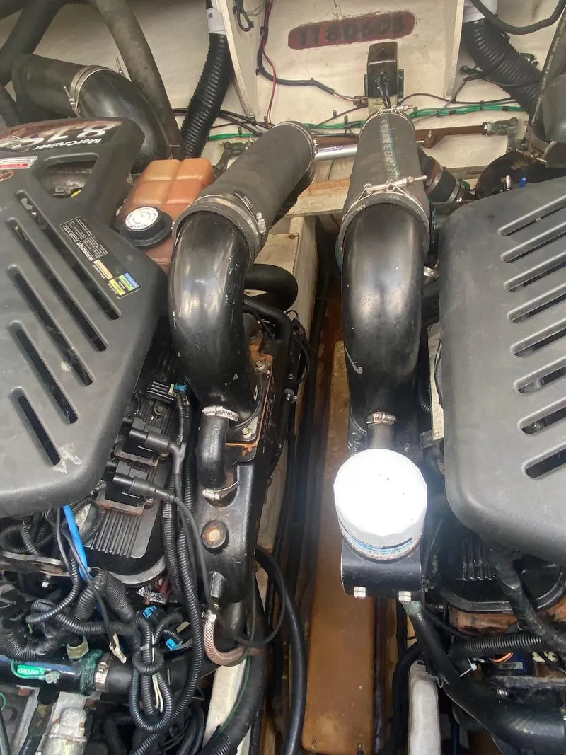 Slide: The Image of 2006 Sea Ray 340 Sundancer engine compartment with twin engines. - 32