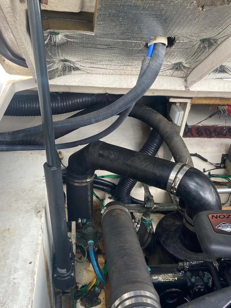 Slide: The Image of Engine compartment of a 2006 Sea Ray 340 Sundancer boat showing hoses and components. - 37