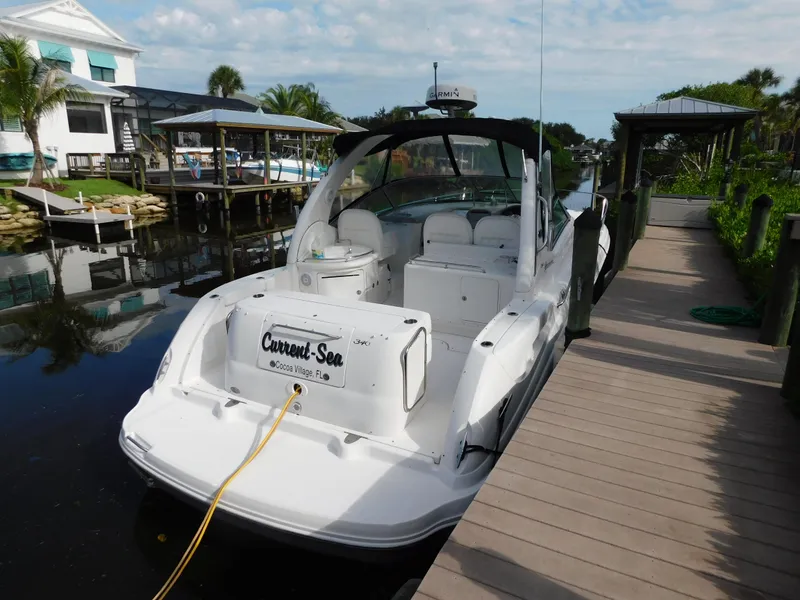 Slide: The Image of 2006 Sea Ray 340 Sundancer docked at a marina with a scenic background. - 5