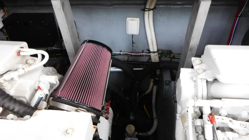 Slide: The Image of Engine compartment of a 2002 Sea Ray 380 Sundancer boat, showcasing mechanical components. - 23