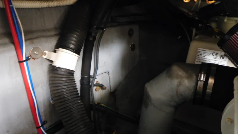 Slide: The Image of Engine compartment of 2002 Sea Ray 380 Sundancer with visible hoses and wiring. - 24