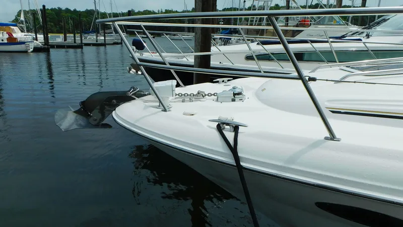 Slide: The Image of 2002 Sea Ray 380 Sundancer docked at marina, showcasing sleek bow design. - 5