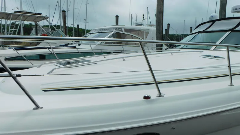 Slide: The Image of 2002 Sea Ray 380 Sundancer yacht docked at marina, featuring sleek design and polished railings. - 7