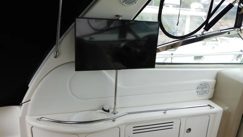 Slide: The Image of Interior of 2002 Sea Ray 380 Sundancer with mounted TV and sleek design elements. - 8