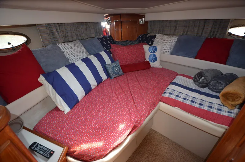 Slide: The Image of Cozy 1991 Carver 33 Aft Cabin interior with colorful bedding and cushions. - 14