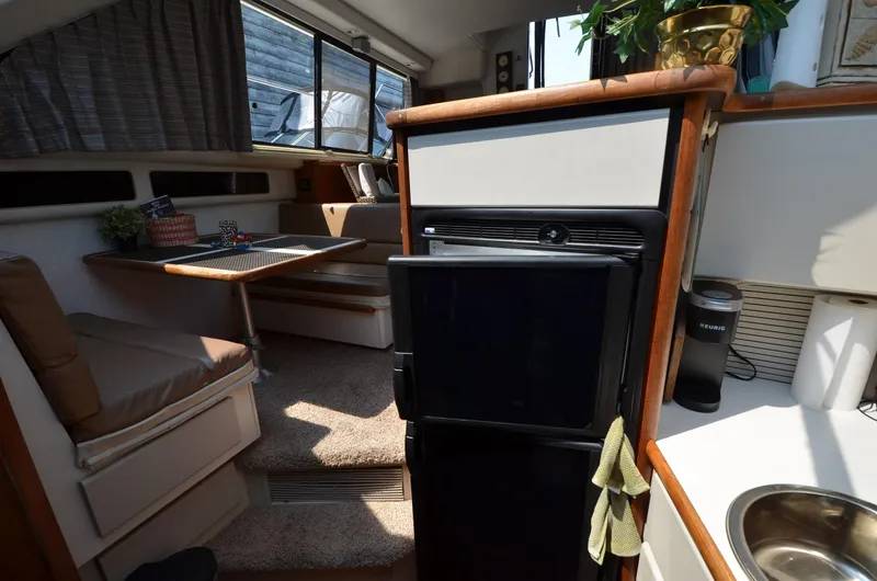 Slide: The Image of Interior of 1991 Carver 33 Aft Cabin yacht with kitchenette and dining area. - 15