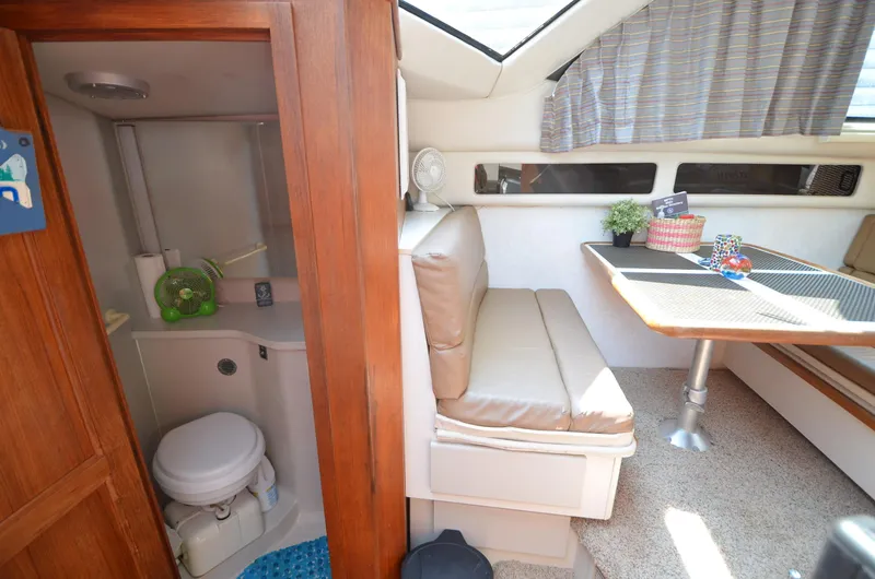 Slide: The Image of 1991 Carver 33 Aft Cabin interior with dining area and compact bathroom. - 18