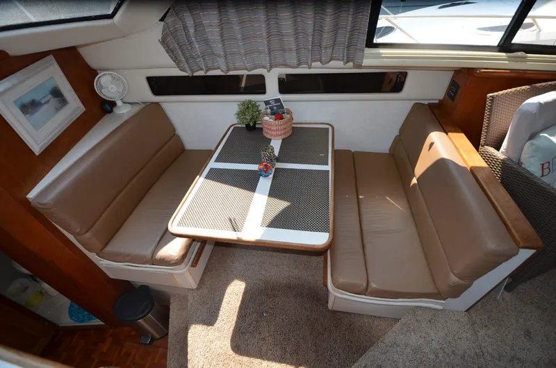Slide: The Image of Interior of 1991 Carver 33 Aft Cabin with cozy dining area and seating. - 19