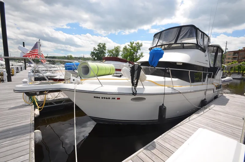 Slide: The Image of 1991 Carver 33 Aft Cabin yacht docked at a marina. - 2