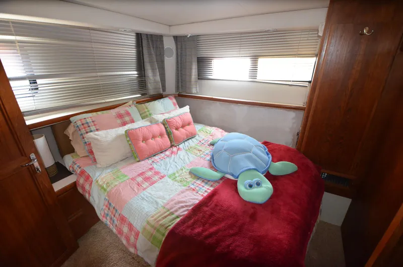 Slide: The Image of Cozy bedroom in 1991 Carver 33 Aft Cabin with colorful bedding and plush turtle. - 26