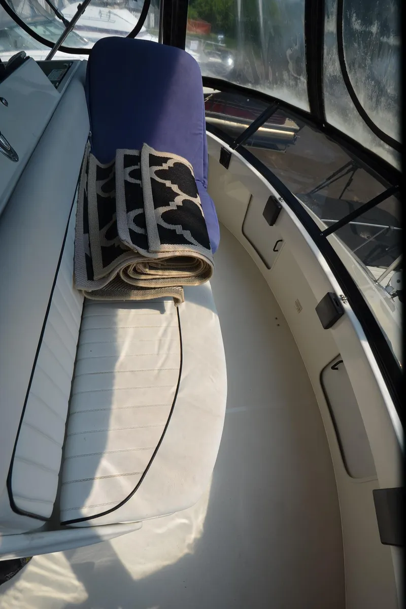 Slide: The Image of 1991 Carver 33 Aft Cabin interior with seating and rolled-up rug. - 32