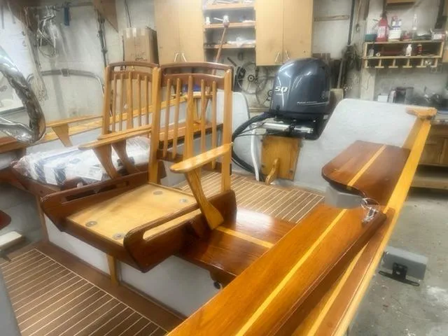 Slide: The Image of Custom 2021 boat interior with wooden seats and Yamaha 50 outboard motor in workshop. - 5
