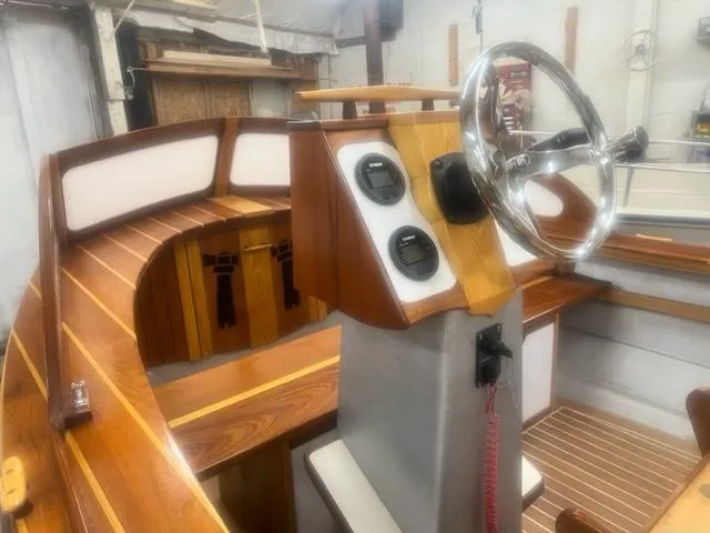 Slide: The Image of Custom 2021 boat interior with wooden finish and steering wheel. - 6