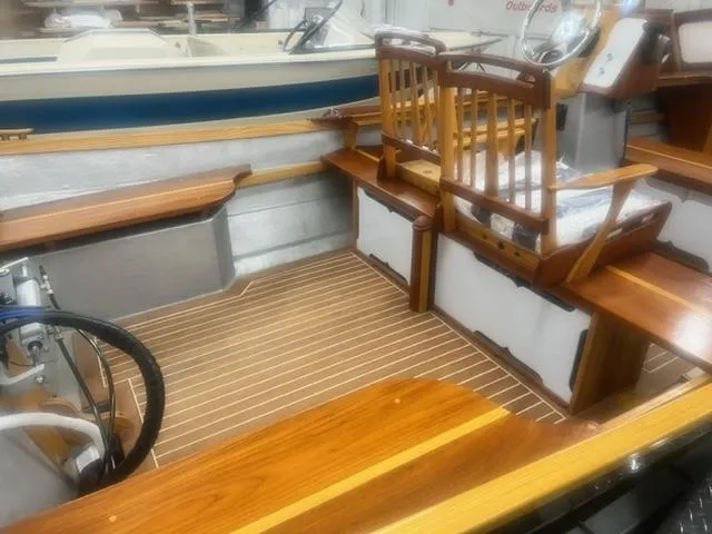 Slide: The Image of Custom 17 boat interior, 2021 model, featuring wooden seats and flooring. - 7