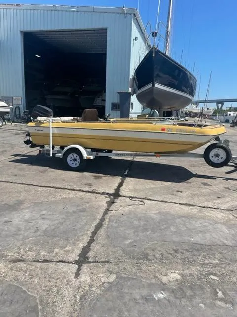 Slide: The Image of 1977 Yarcraft Spirit of 76 boat on trailer outside a large storage facility. - 0